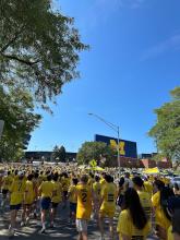 View of student march to Big House on a sunny football Saturday, Block M sign in rear view.