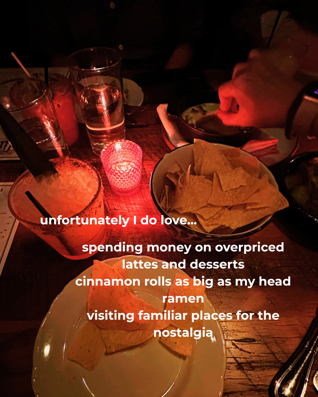 Nicole’s candlelight table with a basket of chips. Text: unfortunately I do love...spending money on overpriced lattes and desserts, cinnamon rolls as big as my head, ramen, visiting familiar places for the nostalgia